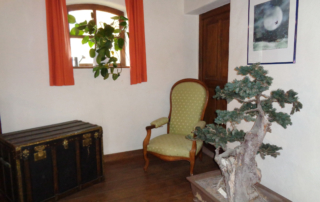 A l'étage, canapé en fer forgé ancien, bibliothèque avec des objets de décoration. 